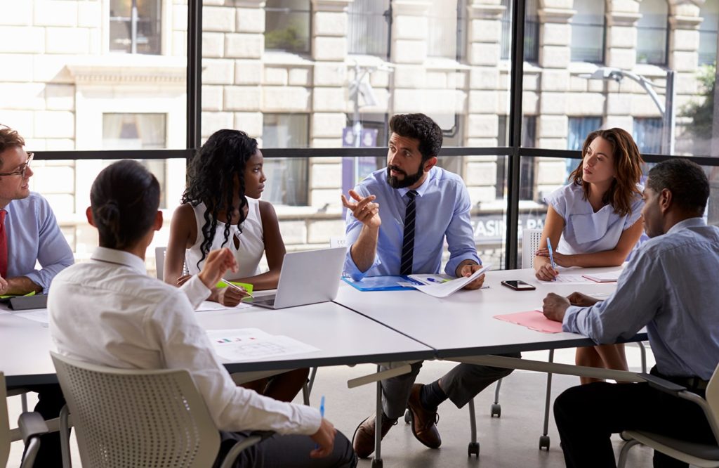 A group of people sitting around a table.