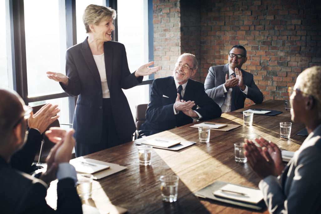 A group of people sitting around a table.
