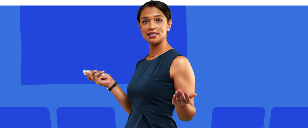 A woman standing in front of a blue background