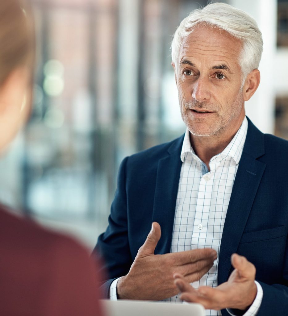 A man in a suit talking to someone